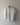 White oversized linen shirt hanging on a hook against a plain wall. The Pippi Shirt