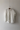 White oversized linen shirt hanging on a hook against a plain wall. The Pippi Shirt